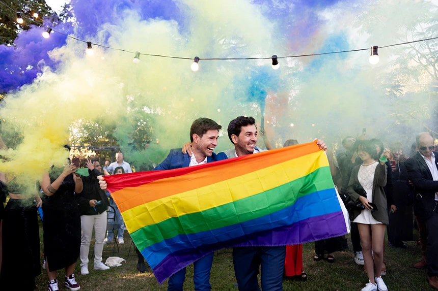 Same-sex couple celebrating with family during their destination wedding in Argentina.